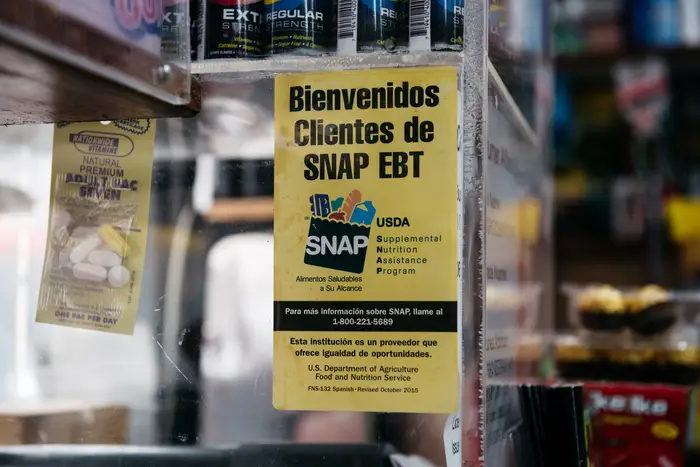 A sign alerting customers about SNAP food stamps benefits is displayed in a Brooklyn grocery store in December 2019 in New York City. The city Department of Social Services estimates there were 50,000 food stamp applications in October 2022, a 60% bump compared to the same month in 2019.